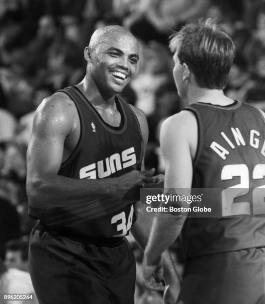 Phoenix Suns Charles Barkley shakes the hand of Boston Celtics Danny Ainge after his team won a game at the Boston Garden, April 2, 1993.