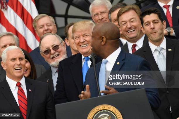 Vice President Mike Pence, US President Donald Trump and House speaker Paul Ryan listen as Republican Senator Tim Scott speaks about the passage of...