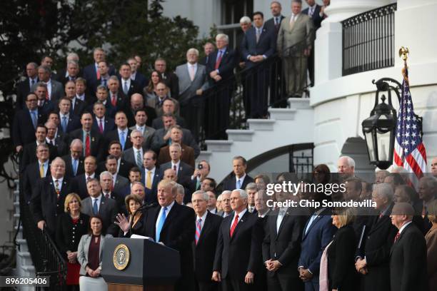 President Donald Trump, flanked by Republican lawmakers, celebrates Congress passing the Tax Cuts and Jobs Act on the South Lawn of the White House...