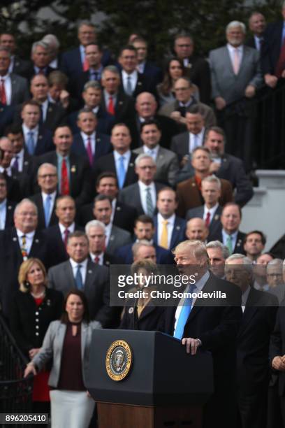 President Donald Trump, flanked by Republican lawmakers, celebrates Congress passing the Tax Cuts and Jobs Act on the South Lawn of the White House...