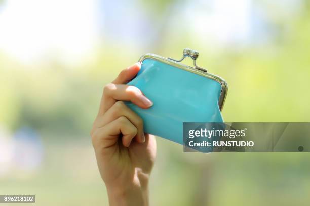 cropped hand holding change purse - purse bildbanksfoton och bilder