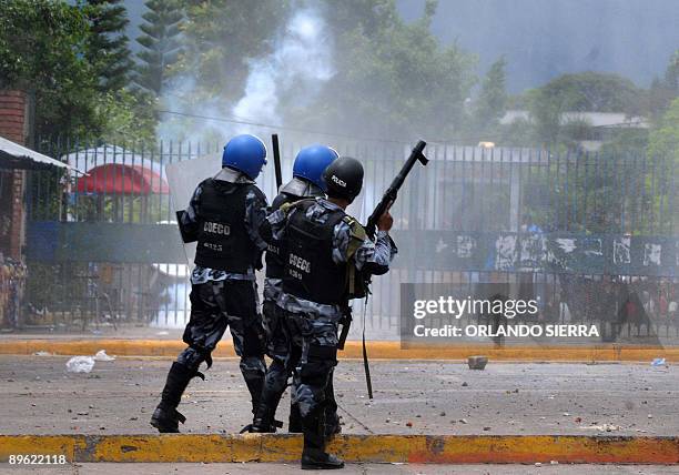 Honduran policemen shoot tear gas against students from the Universidad Nacional Autonoma de Honduras , during a demonstration to demand the...
