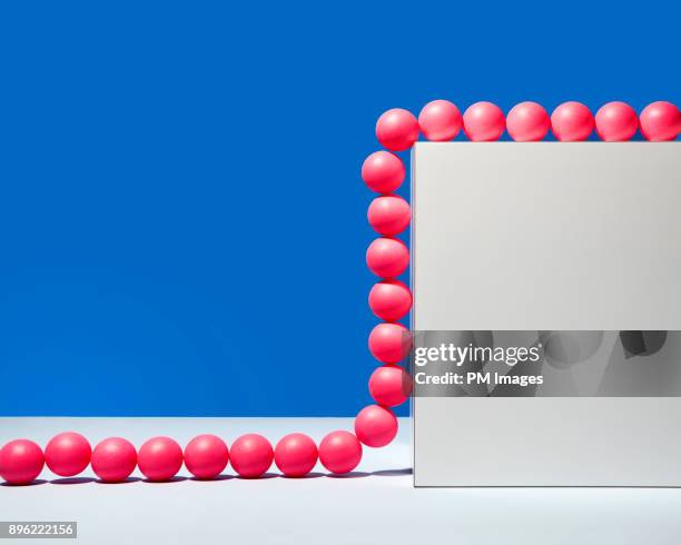 Red balls climbing a wall