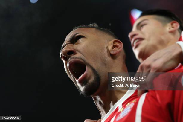 Jerome Boateng of FC Bayern Muenchen celebrates his first goal together with teammate James Rodriguez during the DFB Cup round of sixteen match...