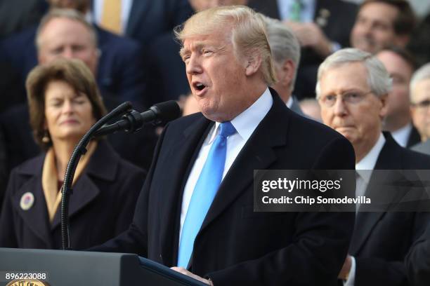 President Donald Trump, flanked by Republican lawmakers, celebrates Congress passing the Tax Cuts and Jobs Act on the South Lawn of the White House...