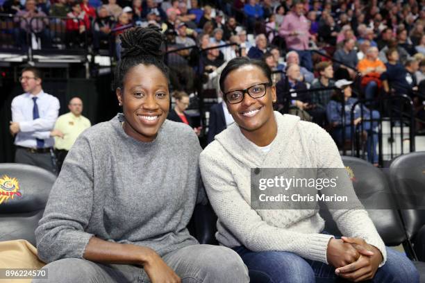 Tina Charles and Ashley Battle come out to celebrate Geno Auriemma of the UConn Huskies on his 1000th career win during the Naismith Basketball Hall...