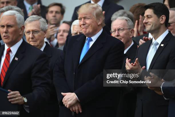 President Donald Trump, flanked by Republican lawmakers, celebrates Congress passing the Tax Cuts and Jobs Act on the South Lawn of the White House...