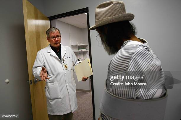 Dr. Thomas Hoffeld, chief of staff at the Spanish Peaks Health Center, speaks with a patient covered by Medicaid on August 5, 2009 in Walsenburg,...