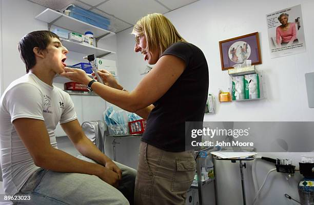 Family nurse practicioner Julie Klaker gives a sports physical to Brian Aguirre at the Spanish Peaks Outreach Clinic on August 5, 2009 in Walsenburg,...