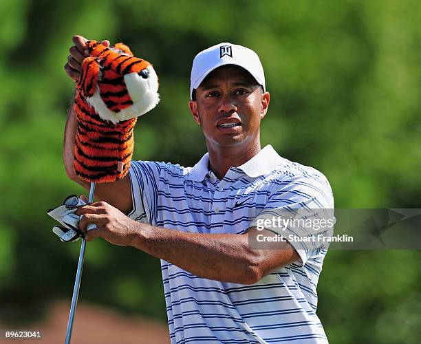Tiger Woods of the U.S. Pulls out a club during a practice round of the World Golf Championship Bridgestone Invitational on August 5, 2009 at...