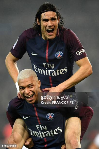 Paris Saint-Germain's French forward Kylian MBappe celebrates with Paris Saint-Germain's Uruguayan forward Edinson Cavani after scoring during the...