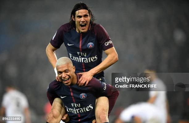 Paris Saint-Germain's French forward Kylian MBappe celebrates with Paris Saint-Germain's Uruguayan forward Edinson Cavani after scoring during the...