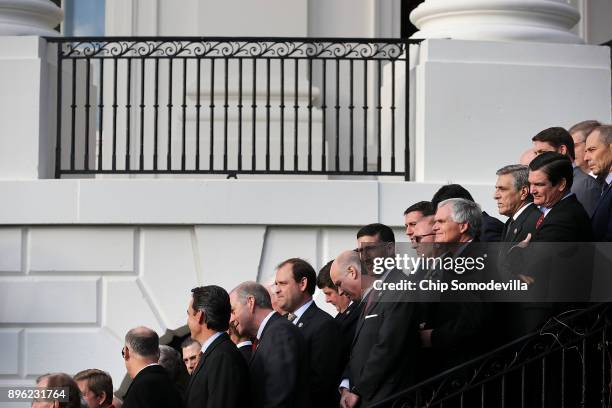 Republican members of Congress line the stairs on the south side of the White House during an event to celebrate Congress passing the Tax Cuts and...