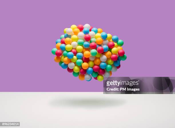 cloud of multi-colored balls - luftballons stock-fotos und bilder