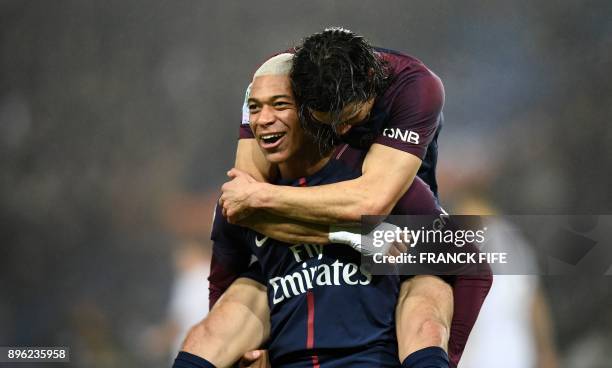 Paris Saint-Germain's French forward Kylian MBappe celebrates with Paris Saint-Germain's Uruguayan forward Edinson Cavani after scoring during the...