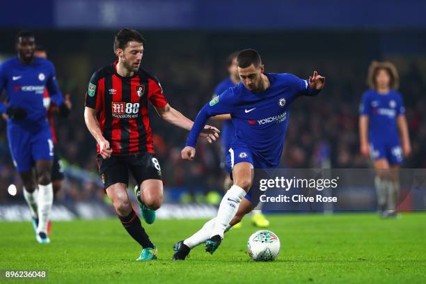 Eden Hazard of Chelsea runs with the ball under pressure from Harry Arter of AFC Bournemouth during the Carabao Cup Quarter-Final match between...