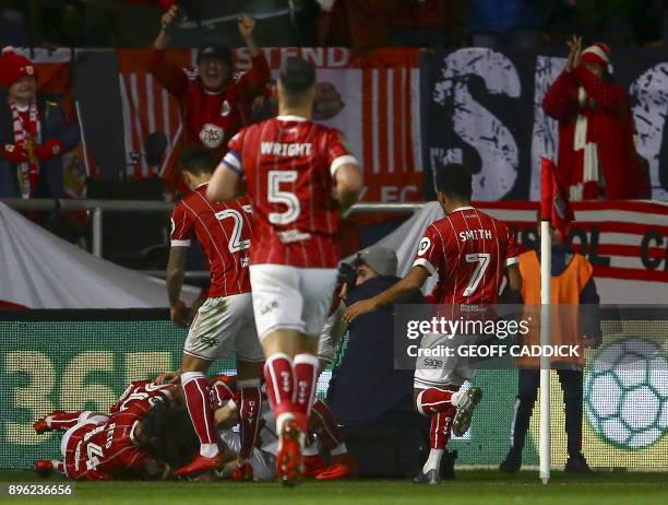 Bristol City's Scottish defender Joe Bryan celebrates with teammates, scoring the team's first goal during the English League Cup quarter-final...