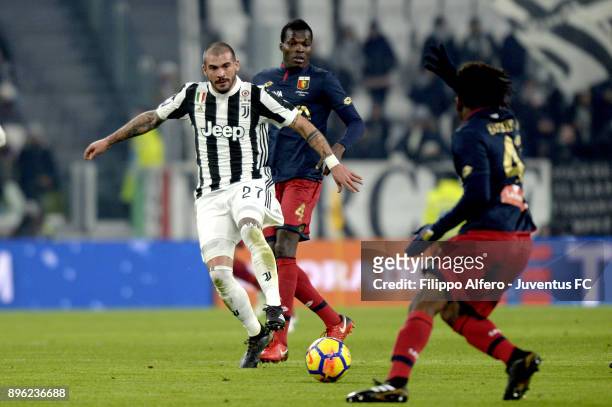 Stefano Sturaro of Juventus competes for the ball with Isaac Cofie and Stephane Omeonga of Genoa CFC during the TIM Cup match between Juventus and...