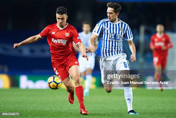 Sebastien Corchia of Sevilla FC being followed by Adnan Januzaj of Real Sociedad during the La Liga match between Real Sociedad and Sevilla at...