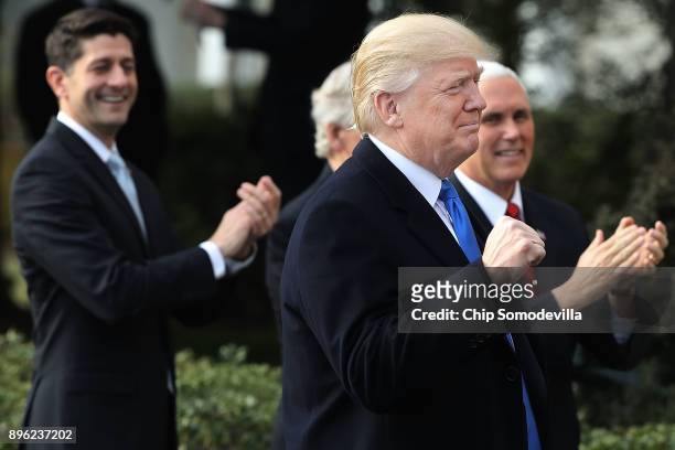 President Donald Trump pumps his fist during an event to celebrate Congress passing the Tax Cuts and Jobs Act with Republican members of the House...