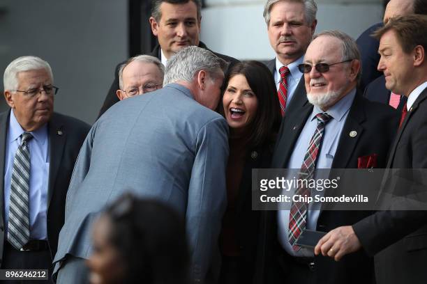 House Majority Leader Kevin McCarthy whispers to Rep. Kristi Noem during an event to celebrate Congress passing the Tax Cuts and Jobs Act with Sen....