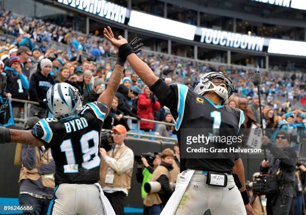 Damiere Byrd celebrates with teammate Cam Newton of the Carolina Panthers after a touchdown against the Green Bay Packers in the fourth quarter...