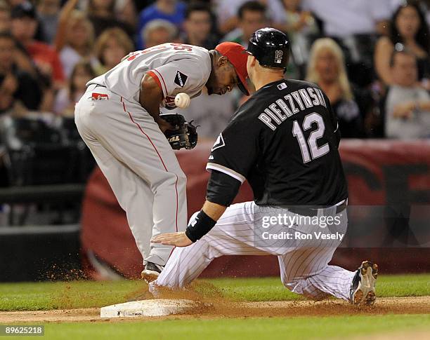 Pierzynski of the Chicago White Sox slides safely into third base in the fifth inning as Chone Figgins of the Los Angeles Angels cannot catch the...