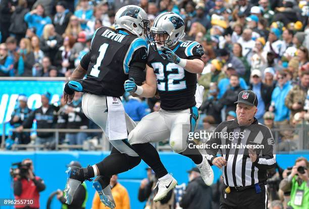 Christian McCaffrey celebrates with teammate Cam Newton of the Carolina Panthers after a touchdown against the Green Bay Packers in the first quarter...