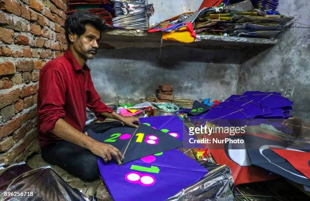 An Indian muslim man kite maker makes paper kites ahead the Hindu Makarsakranti Festival at Ramganj Bazar in Jaipur , Rajasthan , India on 20...