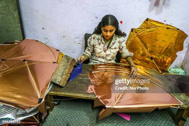 An Indian muslim woman kite maker makes paper kites ahead the Hindu Makarsakranti Festival at Ramganj Bazar in Jaipur , Rajasthan , India on 20...