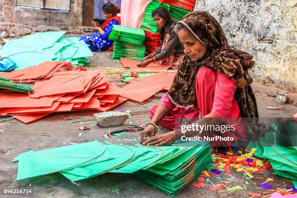 An Indian muslim women kite makers makes paper kites ahead the Hindu Makarsakranti Festival at Ramganj Bazar in Jaipur , Rajasthan , India on 20...