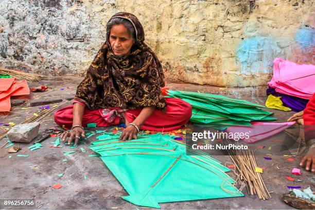 An Indian muslim woman kite maker makes paper kites ahead the Hindu Makarsakranti Festival at Ramganj Bazar in Jaipur , Rajasthan , India on 20...