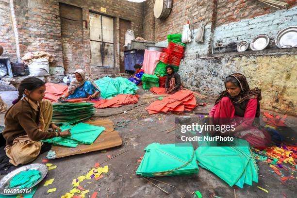 An Indian muslim women kite makers makes paper kites ahead the Hindu Makarsakranti Festival at Ramganj Bazar in Jaipur , Rajasthan , India on 20...