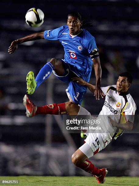 Joel Huiqui of Cruz Azul vies for the ball with Patricio Gomez of Herediano during their 2009 CONCACAF Champions Legue soccer match at the Azul...