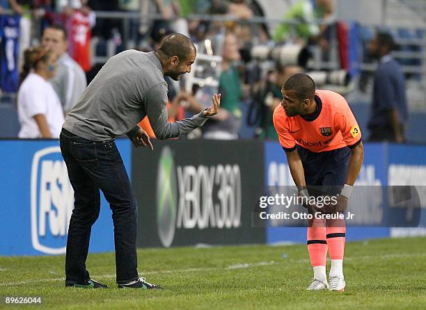 Manager Josep Guardiola of FC Barcelona talks with Daniel Alves during an international friendly match against the Seattle Sounders FC on August 5,...