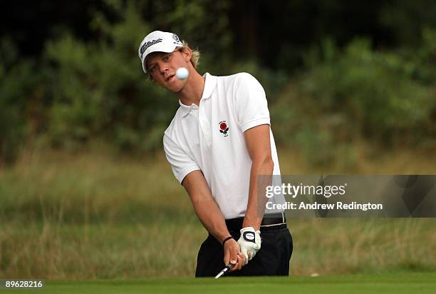 Joshua White of England plays a chip shot on the fourth hole during the morning foursomes on the final day of the Boys Home Internationals at Hankley...