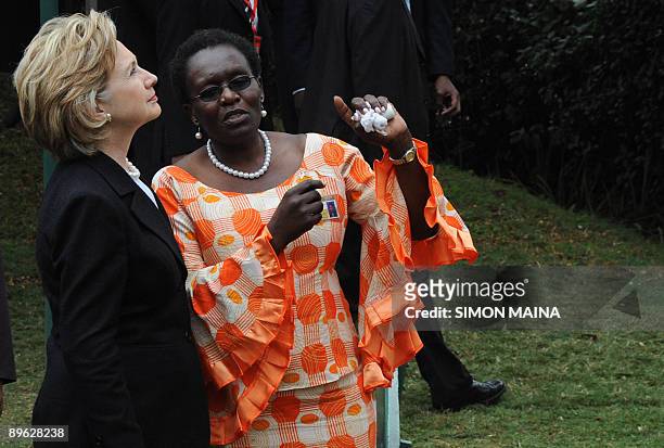 Secretary of State Hillary Clinton is shown around by Judy Ogoye a survivor, after laying a wreath of flowers on the site, on August 6, 2009 of the...