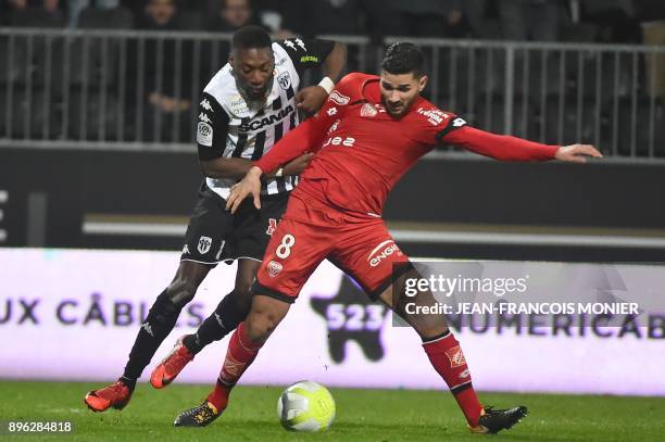 Angers' Cameroonian forward Karl Toko Ekambi vies with Dijon's French-Algerian midfielder Mehdi Abeid during the French L1 Football match between...