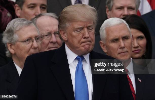 President Donald Trump pauses during an event to celebrate Congress passing the Tax Cuts and Jobs Act with Senate Majority Leader Sen. Mitch...