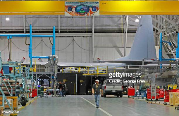 An aircraft mechanic walks the floor as they work on a C-130 cargo plane on December 20, 2017 at Hill Air Force base in Ogden, Utah. Hill Air Force...