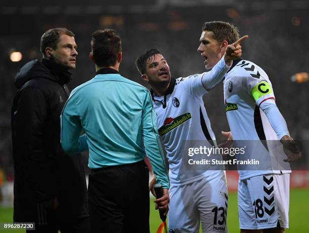 Marco Terrazzino and Nils Petersen of Freiburg speaks with the linesman after the third Bremen goal during the DFB Cup match between Werder Bremen...