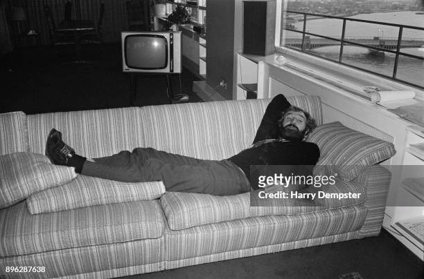 Irish actor and singer Richard Harris lying on a sofa, UK, 17th July 1971.
