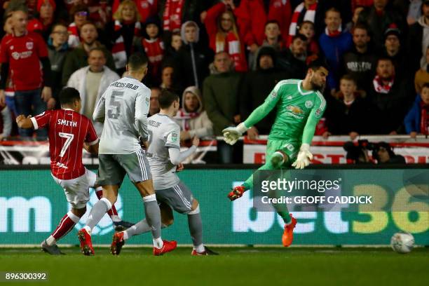 Bristol City's English midfielder Korey Smith scores the team's second goal past Manchester United's Argentinian goalkeeper Sergio Romero during the...