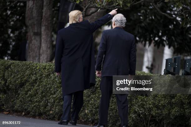 President Donald Trump, left, and Senate Majority Leader Mitch McConnell, a Republican from Kentucky, depart after speaking during a tax bill passage...