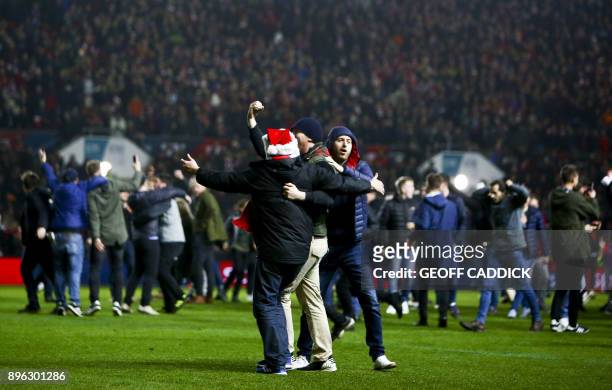 Bristol City fans celebrate their victory as they invade the pitch after the English League Cup quarter-final football match between Bristol City and...