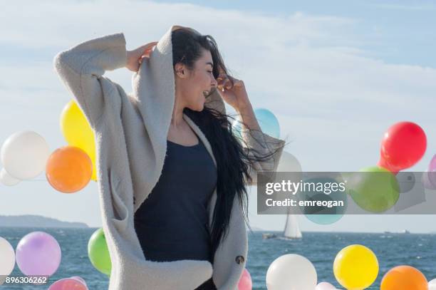 woman and colorful balloons - emreogan stock pictures, royalty-free photos & images