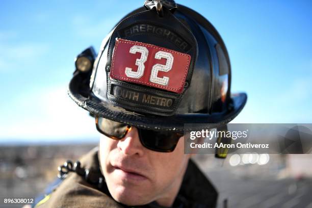 Firefighter Marc Patterson teaches probationary firefighter Shannan Stensvad procedures from the bucket of a ladder truck on December 19, 2017. South...