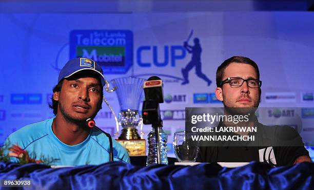 Sri Lankan cricket team captain Kumar Sangakkara speaks as New Zealand cricket team captain Daniel Vettori looks on at a press conference in Colombo...