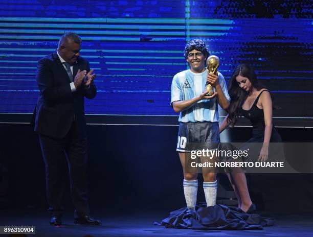 Claudio Tapia , the president of the Argentine Football Association , stands next to a statue of legendary Argentine footballer Diego Armando...