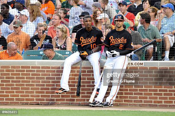 Adam Jones and Nick Markakis of the Baltimore Orioles talk during a break in the game against the Boston Red Sox at Camden Yards on July 31, 2009 in...